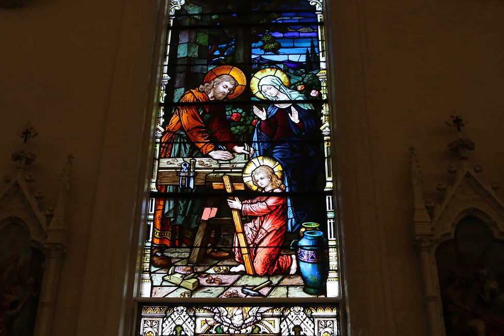 An image of the Holy Family is one of several stained-glass depictions that inspire the parishioners at St. Francis de Sales. Photo by Moira Cullings