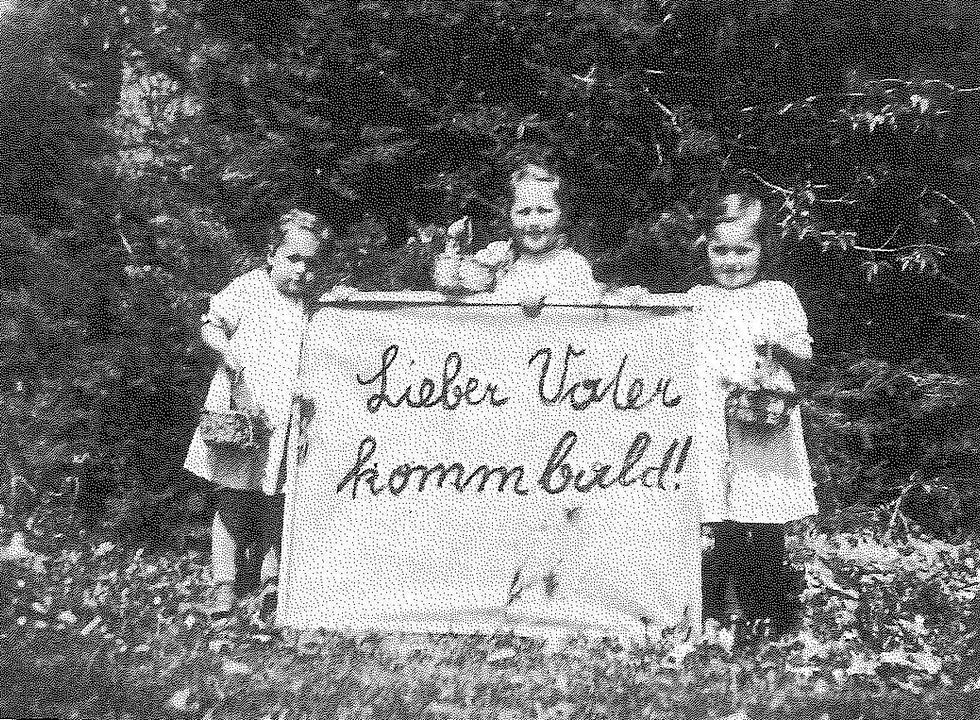 Easter 1943: Franz Jagerstatter's daughters; Loisi, Rosi, and Maria, holding a sign that reads, "Dear Father, come [home] soon." Franz was in jail in Linz and was later executed./ Styria Verlag. Used with permission