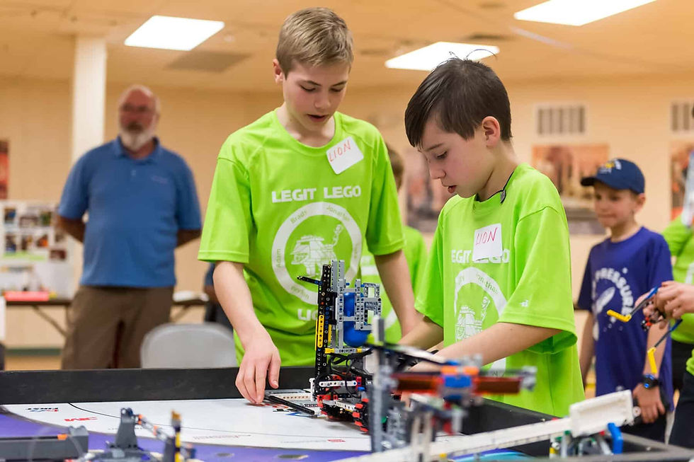Jonathan Alexander (left) and Peyton Gomez work with the team robot during St. Mary’s Innovation Night. Photo by Daniel Petty