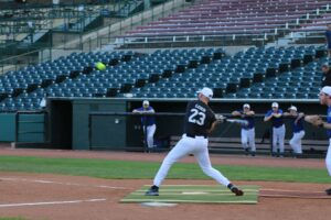 Fr. Darrick Leier hits a grand slam. (Photo provided)