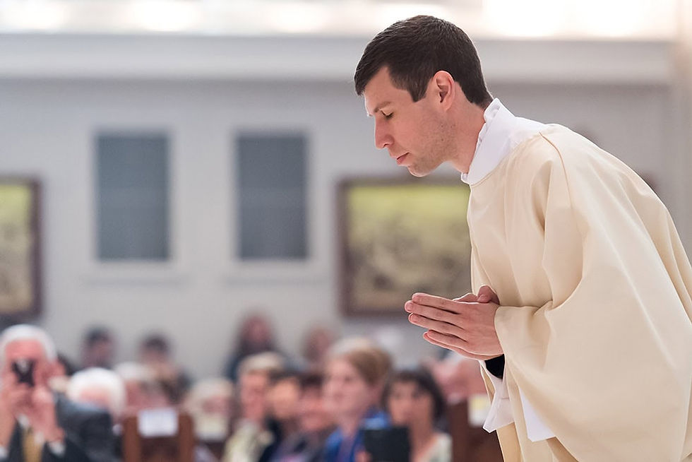 Father Shaun Galvin bowing