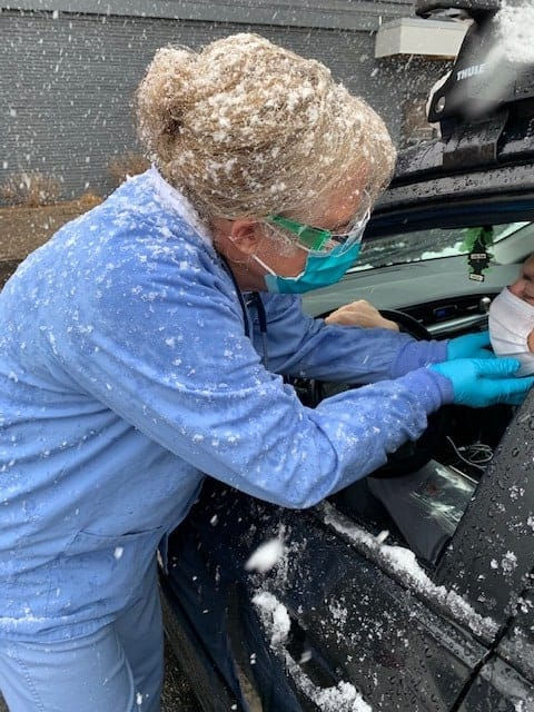 Dede Chism performs a drive-through check up on a patient at Bella Health + Wellness. The clinic is offering drive-through testing for people experiencing COVID-19 symptoms. (Photo from Bella’s Facebook page)