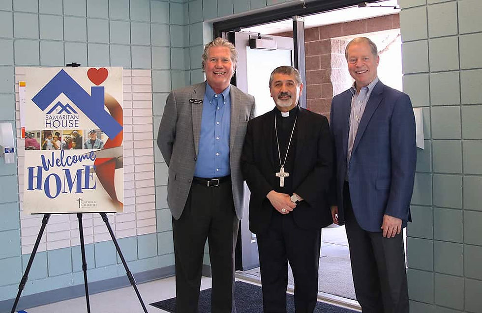 During the ribbon cutting ceremony, Mike Sinnett, vice president of shelters and community outreach for Catholic Charities of Denver, left, stands with Auxiliary Bishop Jorge Rodríguez of the Archdiocese of Denver, center, and Darren Walsh, president and CEO of Catholic Charities of Denver, right. The ceremony and blessing held on May 14 at Samaritan House in Denver celebrated the expansion of services for women seeking shelter, nutritious meals and support services. (Photo courtesy of Catholic Charities)