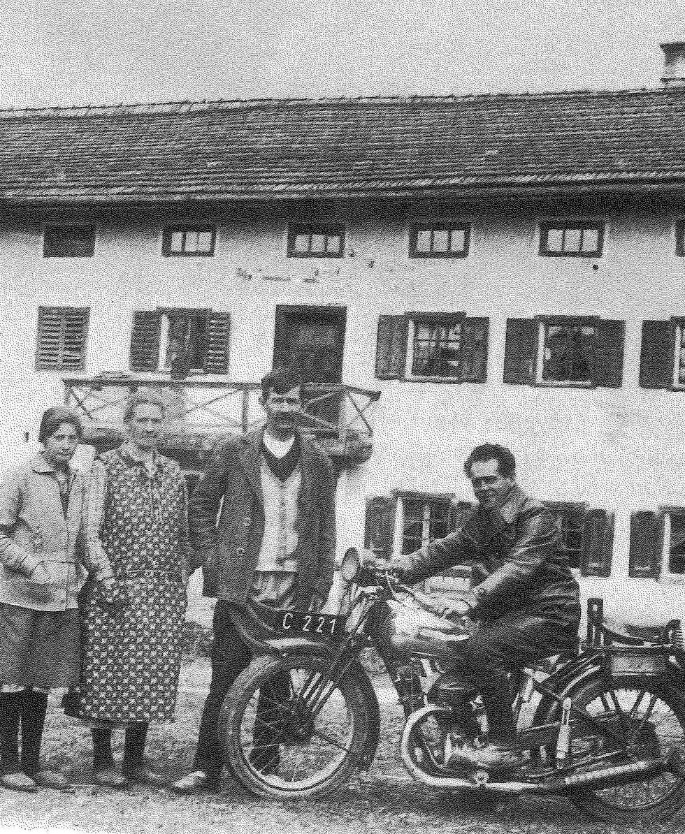  Franz Jagerstatter poses on his motorcycle. From right to left: Franz Jagerstatter; his stepfather, Heinrich Jagerstatter; his mother, Rosalia Jagerstatter; and Aloisia Sommerauer, Franz's cousin and foster sister. / Styria Verlag. Used with permission.