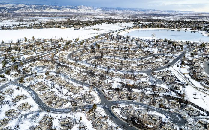 In this aerial view, burned homes sit in a neighborhood decimated by the Marshall Fire on January 4, 2022 in Louisville, Colorado. Officials reported that 991 homes were destroyed in the fire, making it the most destructive wildfire in Colorado history. (Photo by Michael Ciaglo/Getty Images)