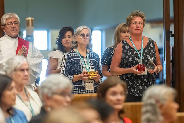 NORTHGLENN, CO - AUGUST 10: People prepare to deliver the gifts during a Deacon Day Mass at Immaculate Heart of Mary Catholic Parish on August 10, 2023, in Northglenn, Colorado. (Photo by Daniel Petty/Denver Catholic)