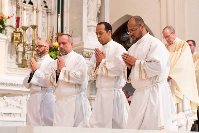 DENVER, CO - FEBRUARY 25: From left, Darrick Leier, Tomislav Tomic, Roberto Jose Rodriguez-Cruz and Angel Miguel Perez-Brown kneel during their Ordination to the Diaconate at the Cathedral Basilica of the Immaculate Conception on February 25, 2017, in Denver, Colorado. (Photo by Daniel Petty/Denver Catholic)