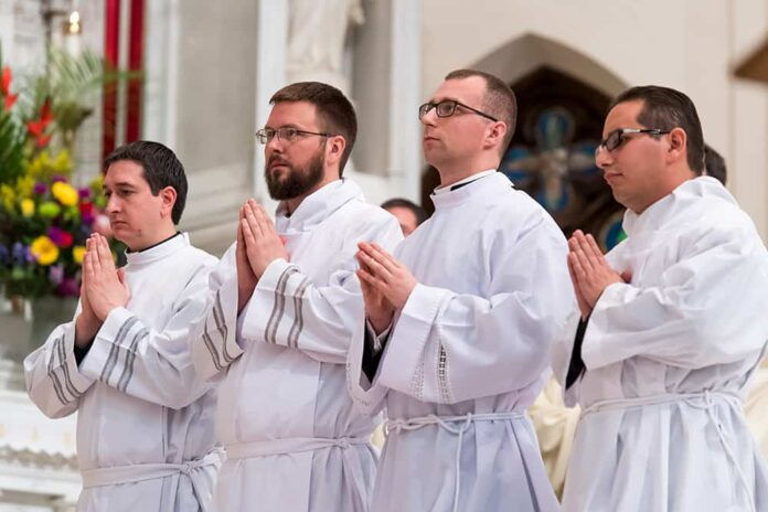 DENVER, CO - FEBRUARY 10: Denver Archbishop Samuel J. Aquila (not pictured) prays over Julio Cesar Amezcua Martin, Mateusz Ratajczak, Witold Kaczmarzyk and Adam Bradshaw during the Mass of Holy Orders Ordination of Deacons at the Cathedral Basilica of the Immaculate Conception on February 10, 2018, in Denver, Colorado. (Photo by Anya Semenoff/Denver Catholic)