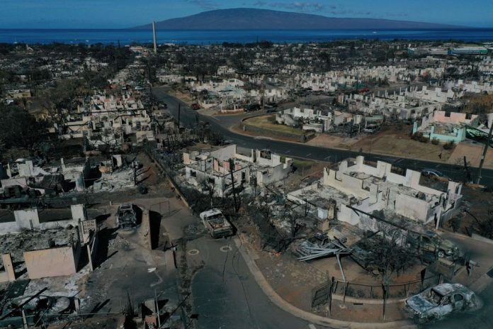 An aerial image shows destroyed homes and vehicles after a wind driven wildfire burned from the hills through neighborhoods to the Pacific Ocean, as seen in the aftermath of the Maui wildfires in Lahaina, Hawaii, on August 17, 2023. (Photo by PATRICK T. FALLON/AFP via Getty Images)