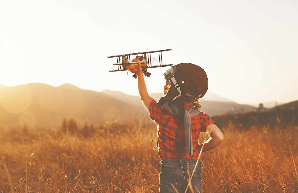 happy child dreams of traveling and playing with an airplane pilot aviator in outdoor in the summer