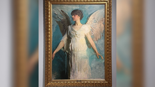 Framed painting of a woman with one dark and one light wing in a white dress, hanging on a gray museum wall.