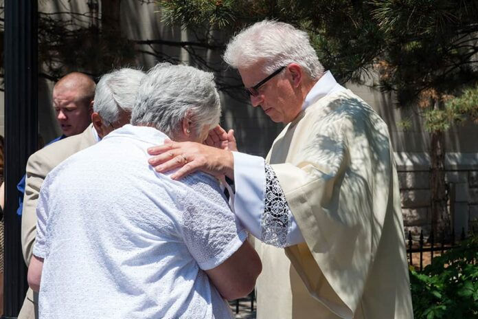 DENVER, CO - JUNE 20: Stan Rymes blesses a friend after the deacon ordination for the Archdiocese of Denver at the Cathedral Basilica of the Immaculate Conception on June 20, 2015, in Denver, Colorado. (Photo by Anya Semenoff/Denver Catholic)