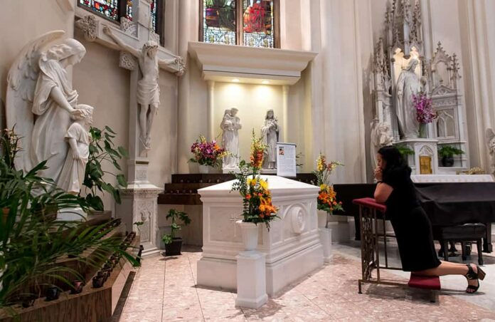 DENVER, CO - JUNE 7: People pray before the tomb of Servant of God Julia Greeley before the 100th Anniversary Mass of her death at the Cathedral Basilica of the Immaculate Conception on June 7, 2018, in Denver, Colorado. (Photo by Anya Semenoff/Denver Catholic)
