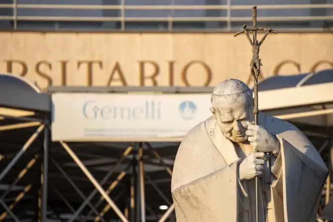 A statue of St. John Paul II is seen in front of the entrance to Rome’s Gemelli Hospital on Feb. 22, 2025, where Pope Francis continues to receive treatment for respiratory issues. | Credit: Daniel Ibáñez/CNA