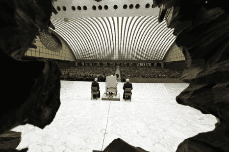 A view of Pope Francis addressing the faithful from the stage of the Vatican’s Paul VI Audience Hall during the first Jubilee audience of 2025, seen through the distinctive carved stone entranceway. (Photo: Vatican Media)