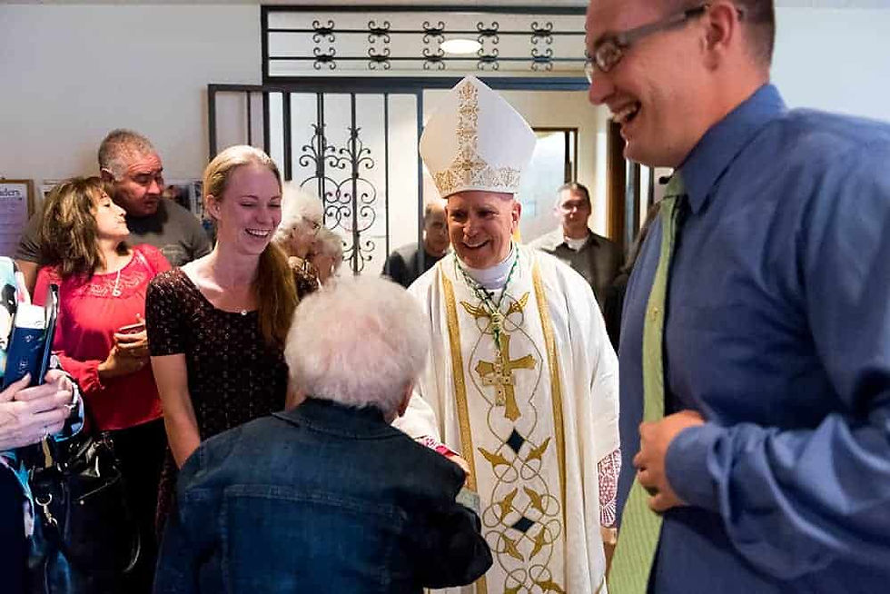 Archbishop Samuel J. Aquila greets parishioners