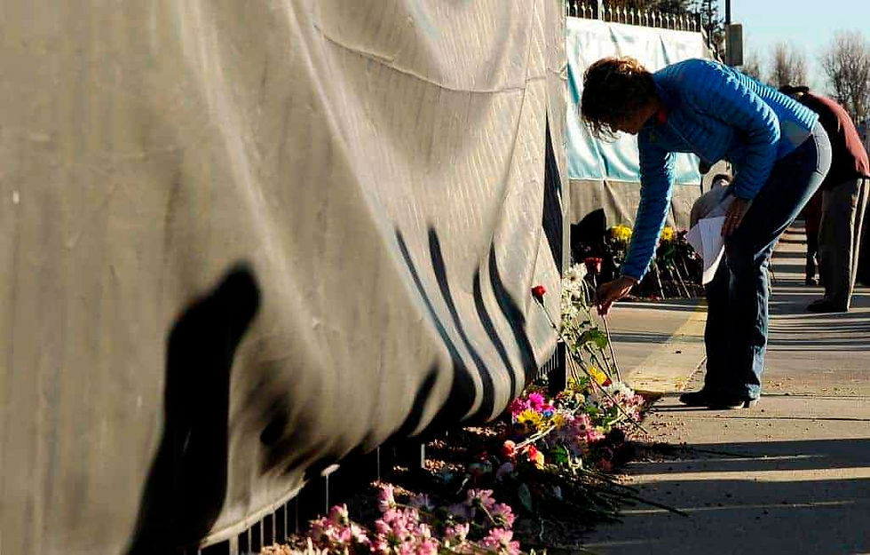 A woman places flowers outside Planned Parenthood during a prayer event