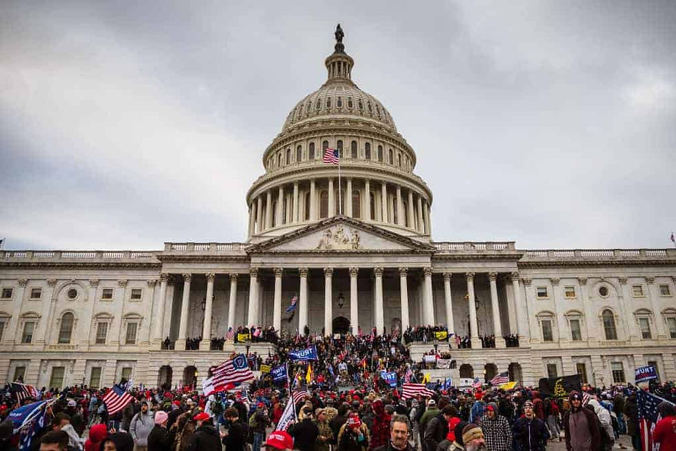Pro-Trump protesters stand on the steps of the Capitol building
