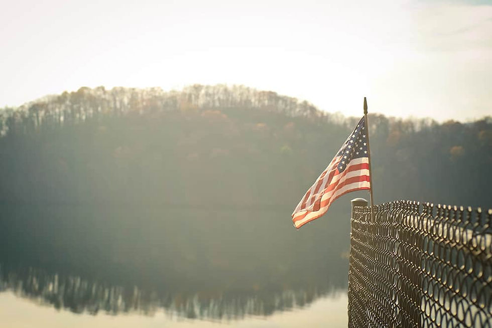 American flag flying near a lake