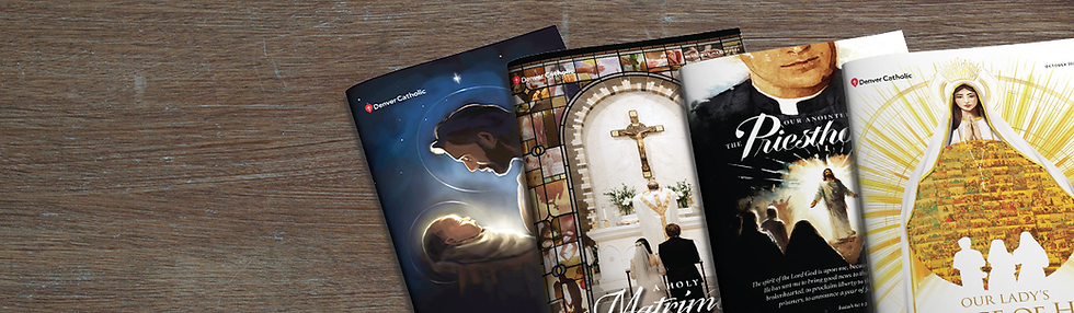 Four print editions of the Denver Catholic arranged on a wooden table, various covers of the complimentary print magazine.