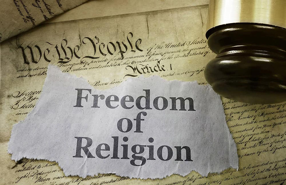 Paper reading "Freedom of Religion" on top of the U.S. Constitution