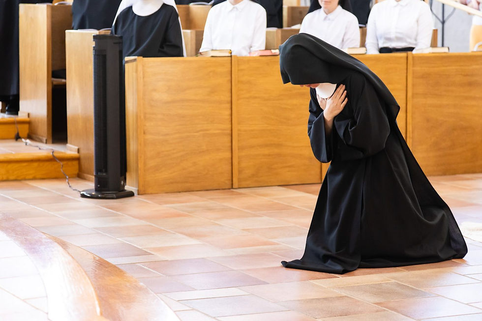 A nun of the Abbey of St. Walburga prays during her Solemn Monastic Profession, committing her life to prayer and praise to God for the Church in perpetuity. (Photo by André Escaleira, Jr.)
