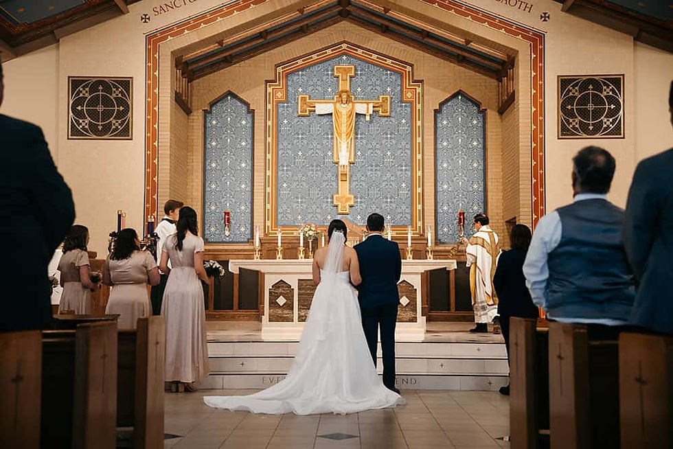 Bride and groom standing at front of Holy Name Parish