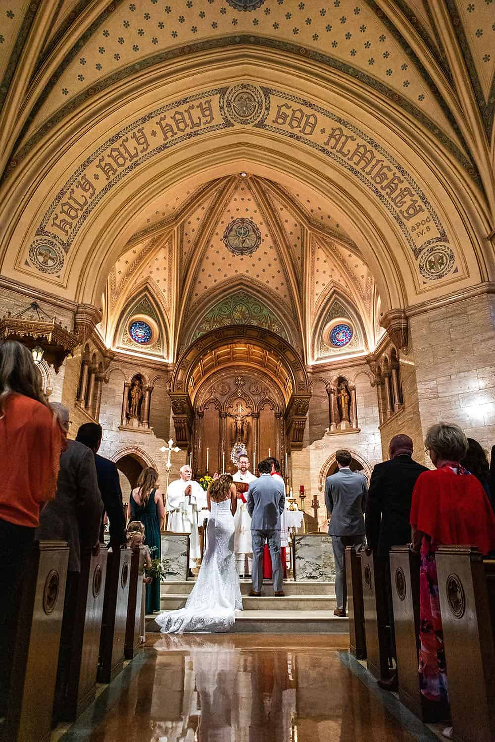 Bride and groom stand at the front of a church
