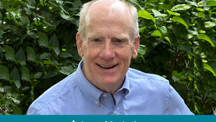 Smiling man in a blue shirt stands in front of lush green foliage. Text below reads "Appeal in Action" with a cross symbol.