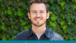 Smiling man in denim shirt with green leafy background. Text: "Appeal in Action" on bottom. Bright, cheerful mood.
