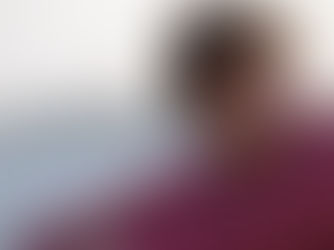 Young person in a red hoodie laughing on a beach with blurred background. Bright mood. "Prime Video" logo in the corner.
