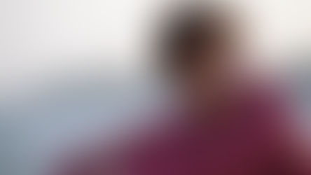 Young person in a red hoodie laughing on a beach with blurred background. Bright mood. "Prime Video" logo in the corner.