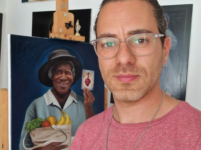 Artist Ruben Ferreira poses with his new painting of Julia Greeley. Photo courtesy of Ruben Ferreira.
