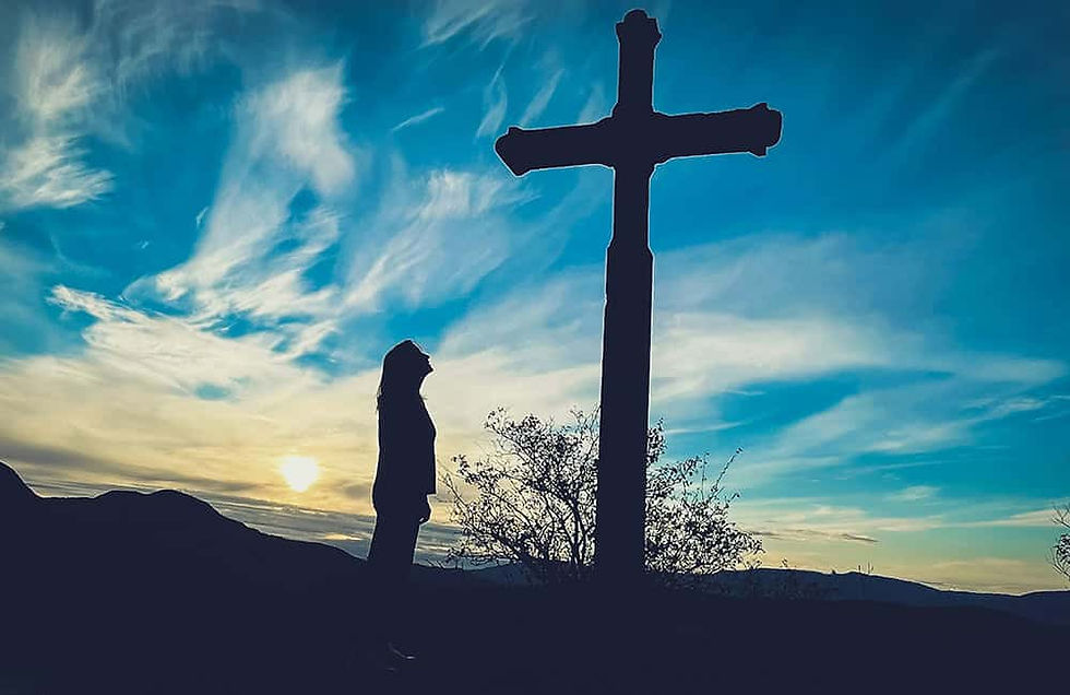 Woman looking up at cross