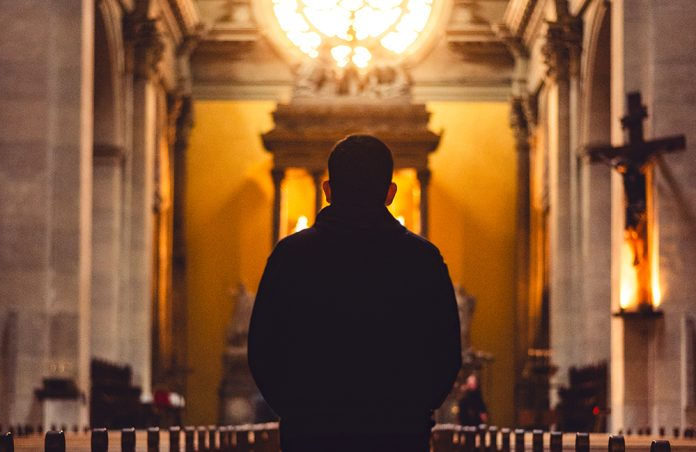 Man standing before a tabernacle