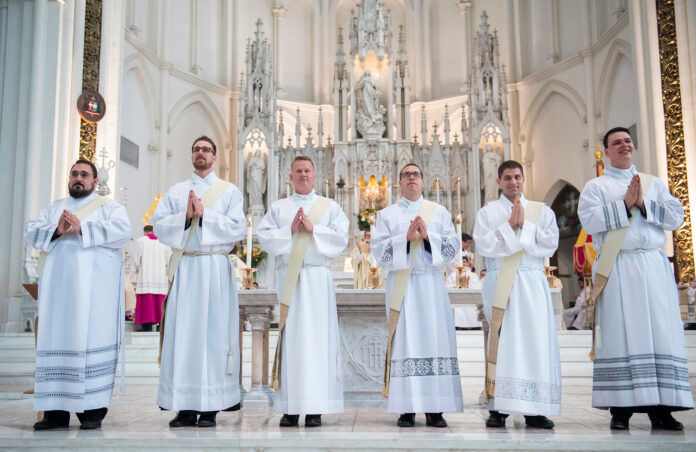 DENVER, CO - MAY 15: From L-R, Deacons John Paul Almeida, Sean Conroy, John Croghan, Anthony Davis, John Stapleton IV and Peter Srsich stand before the congregation during their ordination to the priesthood at the Cathedral Basilica of the Immaculate Conception on May 15, 2021, in Denver, Colorado. (Photo by Anya Semenoff/Denver Catholic)