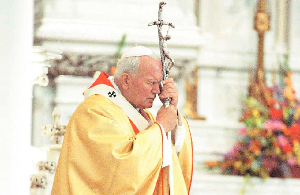 St. John Paul II holding a crucifix