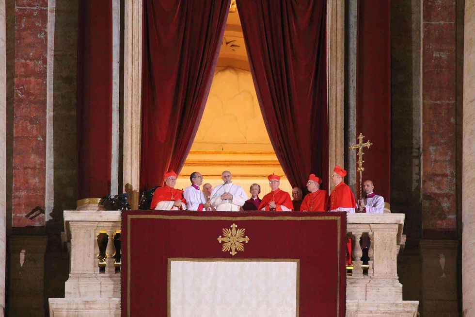 Pope Francis surrounded by cardinals standing on the balcony