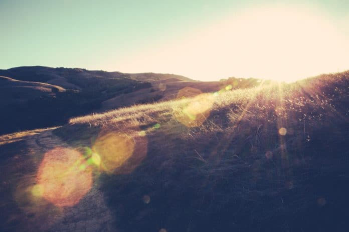 Sun coming over the hill