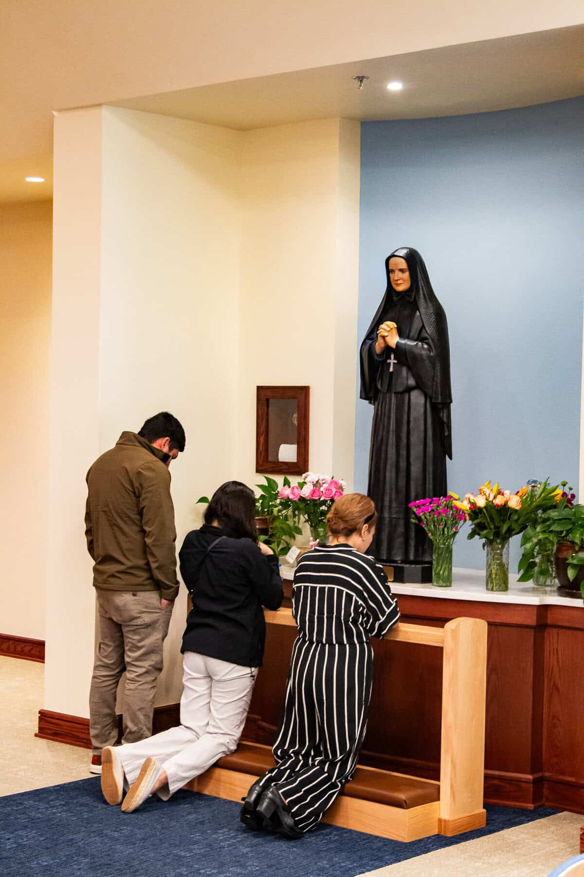 Devotees of Mother Cabrini pray for her intercession following Mass.
