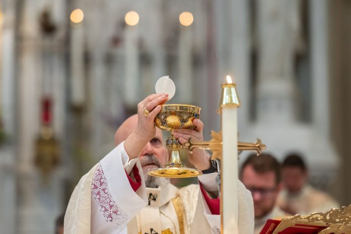 Archbishop Samuel Aquila elevates the Eucharist