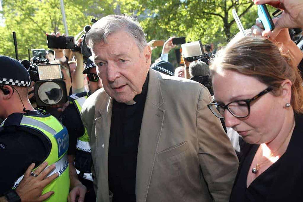 Cardinal George Pell surrounded by reporters