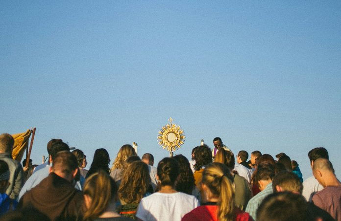 People surrounding a monstrance