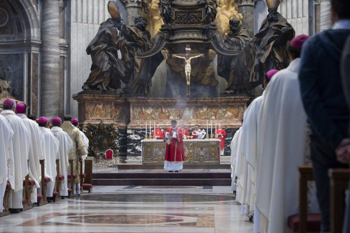 Priest with incense in a Mass with many cardinals