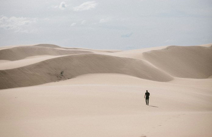Man walking alone in desert