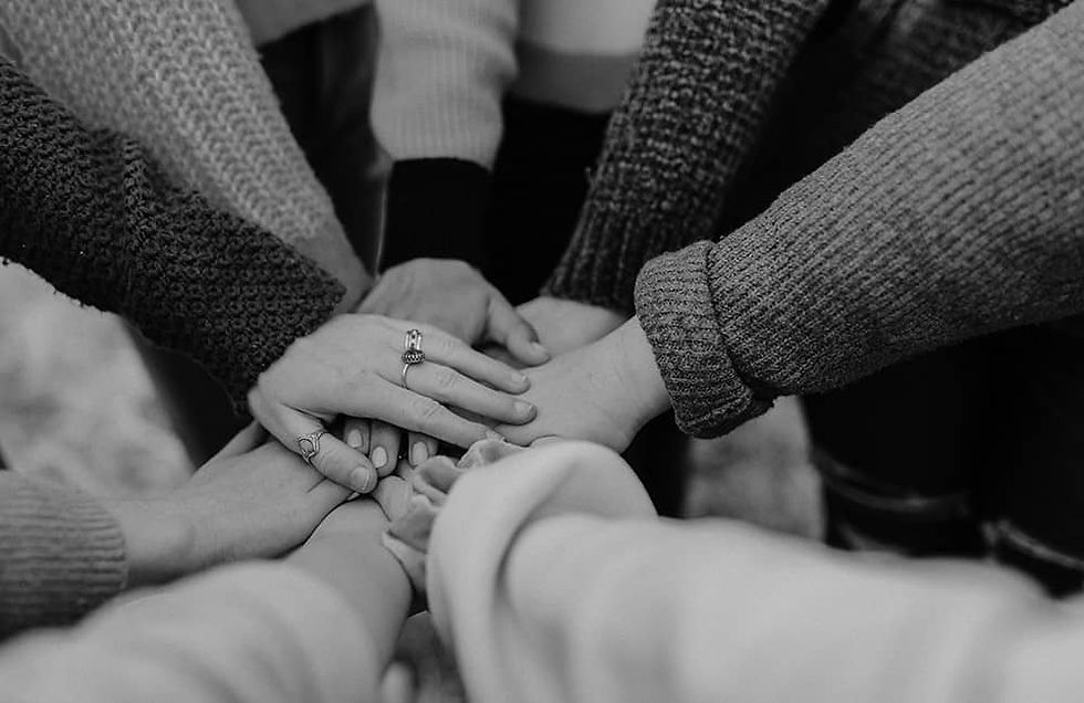 Many hands reaching together