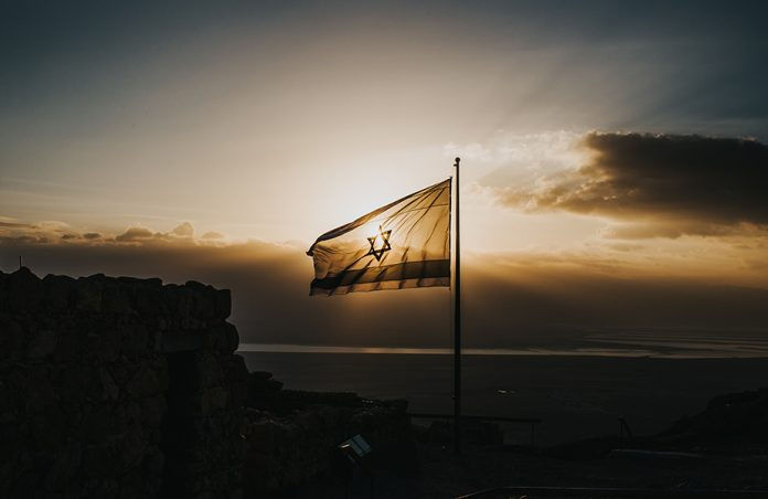 Israel's flag in front of sunset