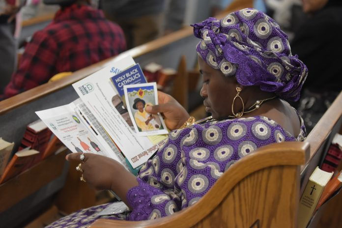 Hedjine Tamajong, a parishioner at Queen of Peace Parish and pictured here reading through the reflection materials, was one of the 50+ attendees at the Day of Reflection hosted by the Office of Black Catholic Ministry last autumn. (Photo courtesy of the Office of Black Catholic Ministry)