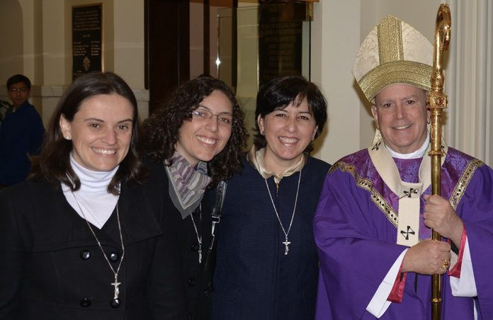 From left to right, Fraternas Carmen Villa, Lara Montoya and Mayé Agama with Archbishop Samuel J. Aquila. (File photo)